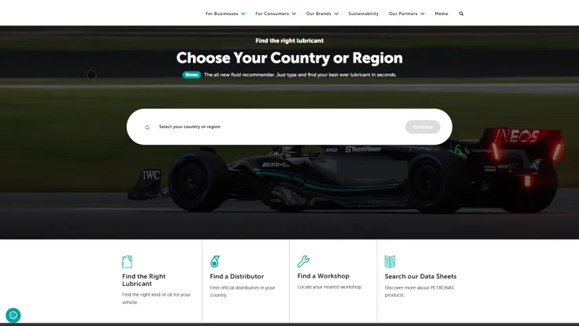 Petronas Lubricants homepage with a country selector over a racing car photograph and links to lubricant, distributor and workshop searches.
