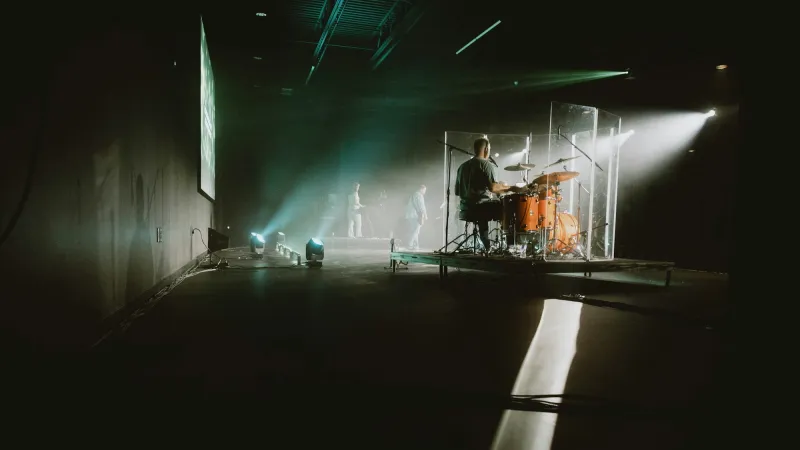 Musicians on a stage lit by spotlights